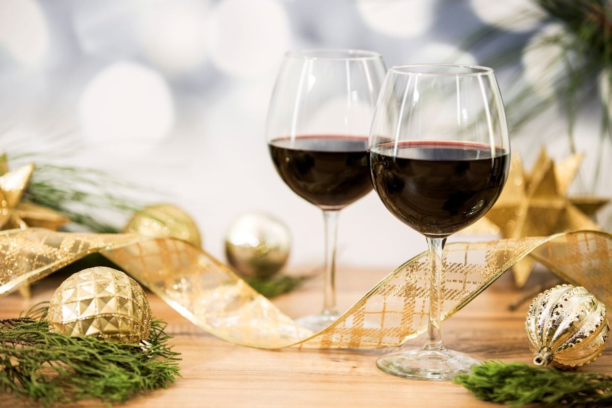 holiday decor with two poured red wines in glasses